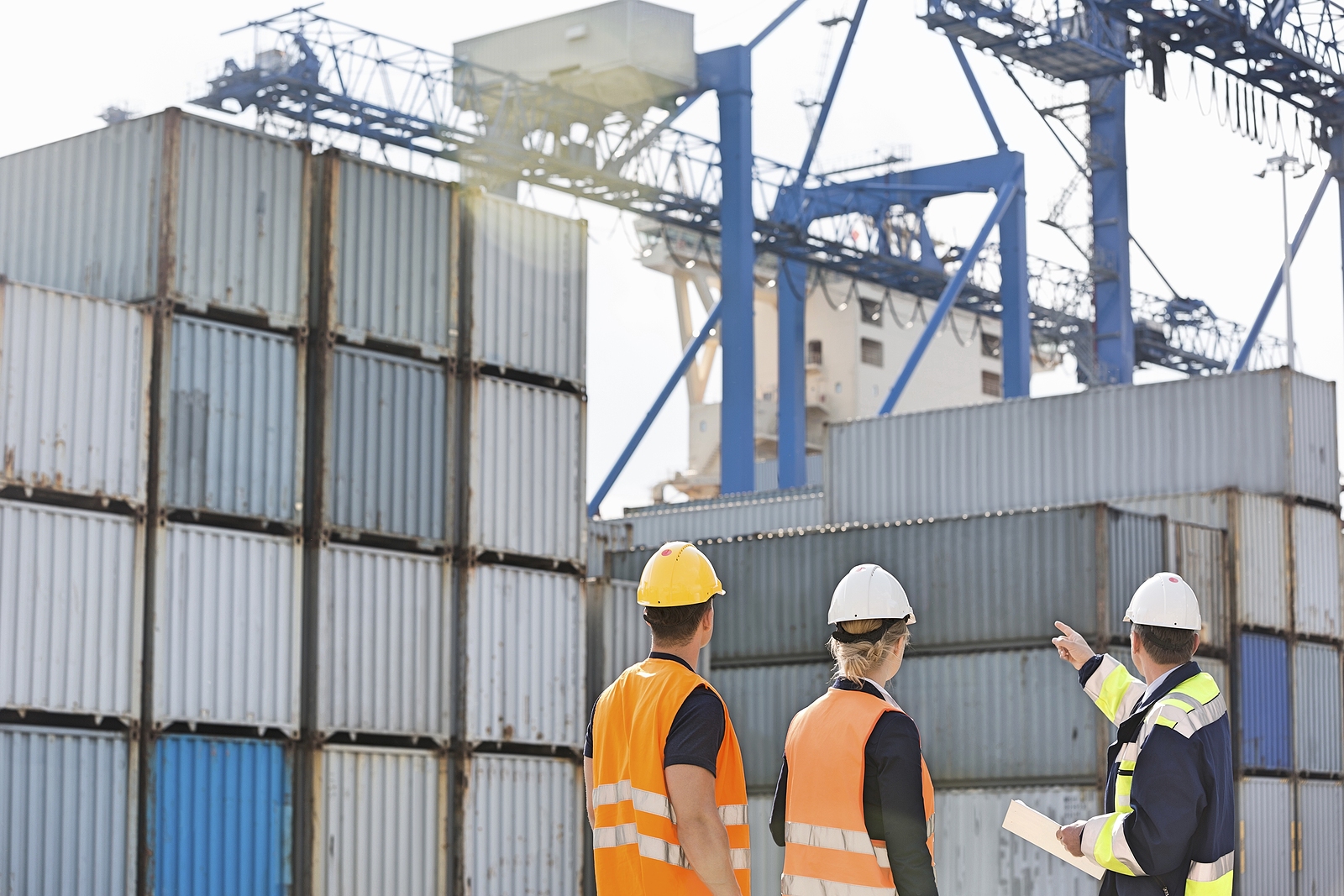 Modified shipping containers - workers inspecting cargo container